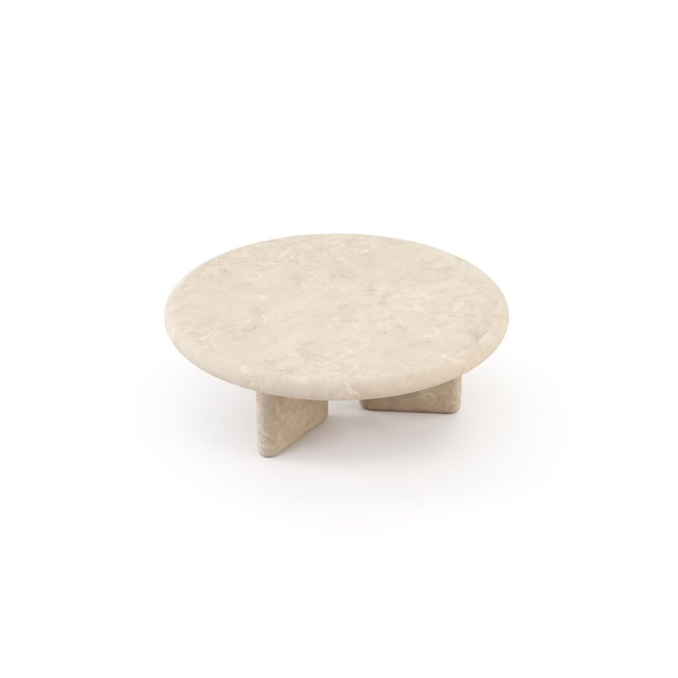 The Foz Coffee Table shown at a low angle, its circular microcement top and two angled supporting legs revealing the material's natural, weathered texture. The rounded form and tactile finish capture the calm, gathering quality at the heart of this contemporary center table.