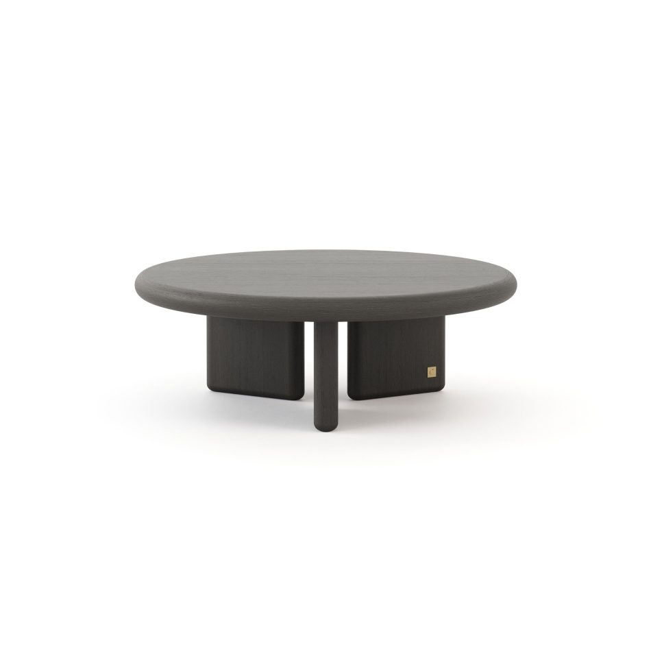 The Foz Coffee Table in dark wood shows a smooth circular top supported by three organic legs, creating a grounded and balanced silhouette. The natural grain adds quiet depth, making it a warm presence within luxury living room furniture, thoughtful home furniture, curated design details, and modern living room inspiration.