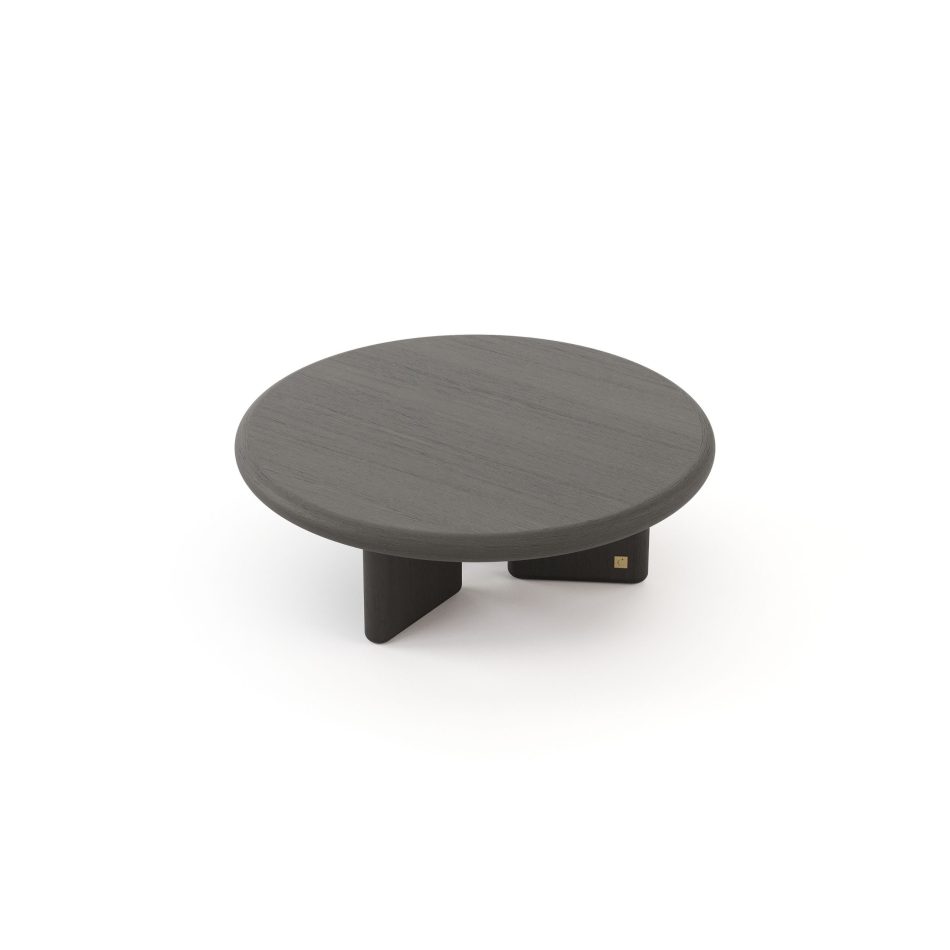 The Foz Coffee Table appears with a round wooden top resting over three wide legs arranged in a soft triangular rhythm. Its minimalist form highlights the wood’s texture, offering a calm focal point suited to modern furniture, elegant luxury home furniture, warm living room furniture, and subtle interior design inspiration.