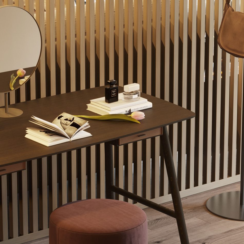 The Landform Dressing Table appears within a serene dressing area, its wooden top arranged with books, perfume bottles, and a single tulip that adds a quiet touch of color. The round mirror rises lightly above the surface, completing a composition rooted in simplicity and calm proportion. The space reflects crafted home furniture, soft mid‑century influences, and understated design details, bringing modern luxury bedroom furniture into an interior shaped for gentle interior design inspiration.