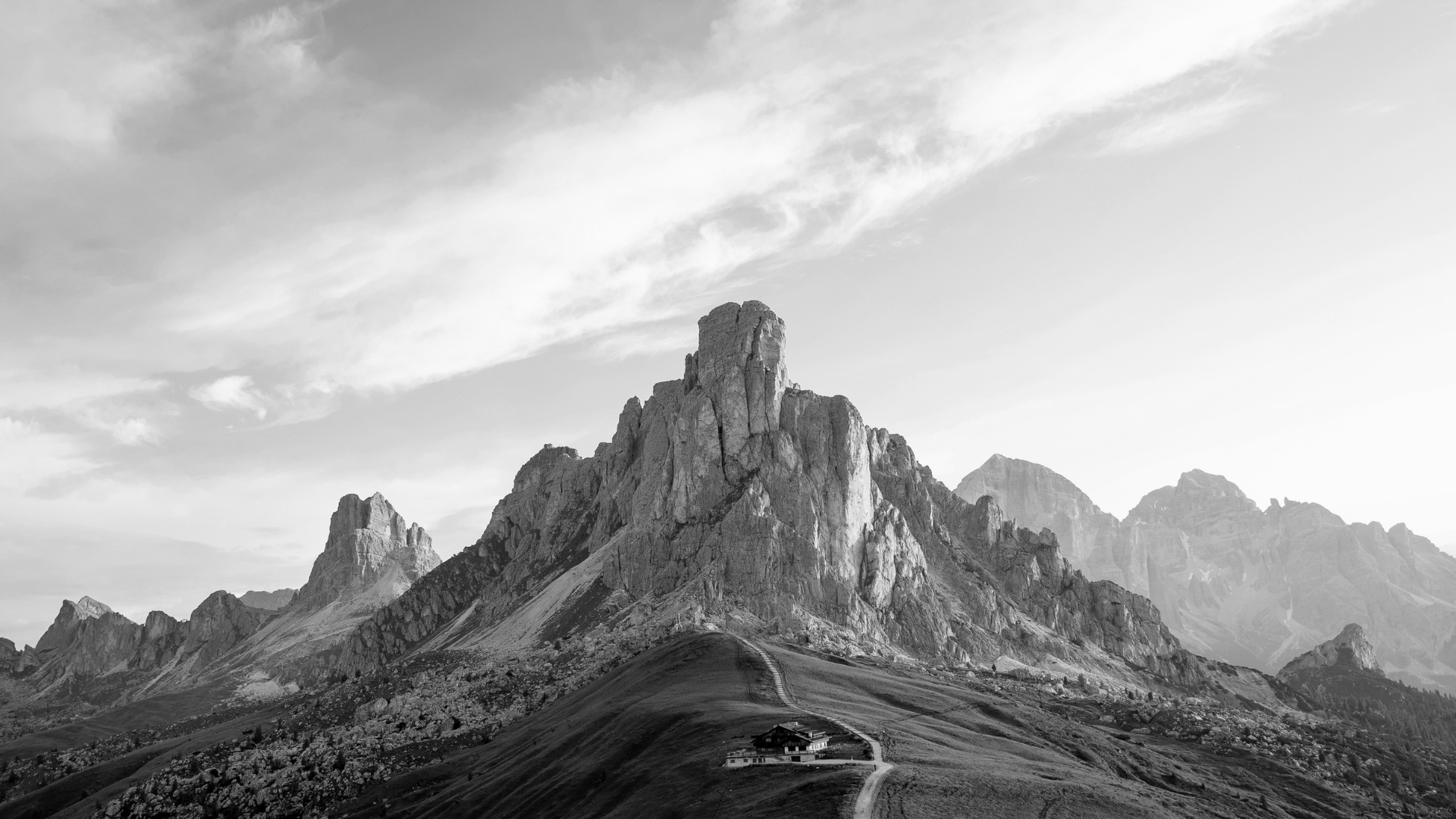 Black and white photograph of majestic mountain peaks in the Dolomites, inspiring contemporary furniture design through a minimalist design philosophy and high-end interior design inspiration.