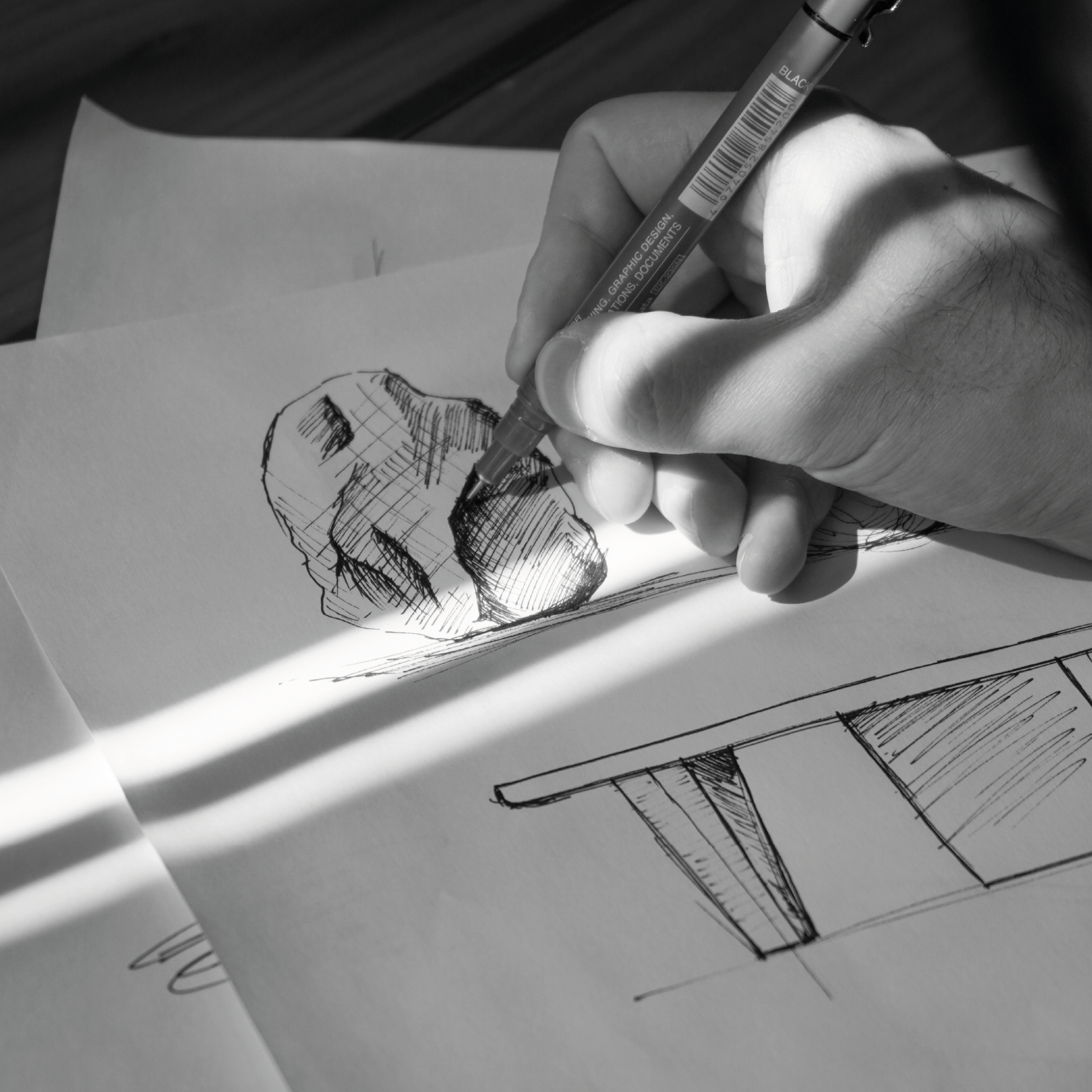 Hand-drawing sketches of natural stone forms and contemporary furniture, illustrating the initial design details and process behind bespoke furniture and modern furniture.