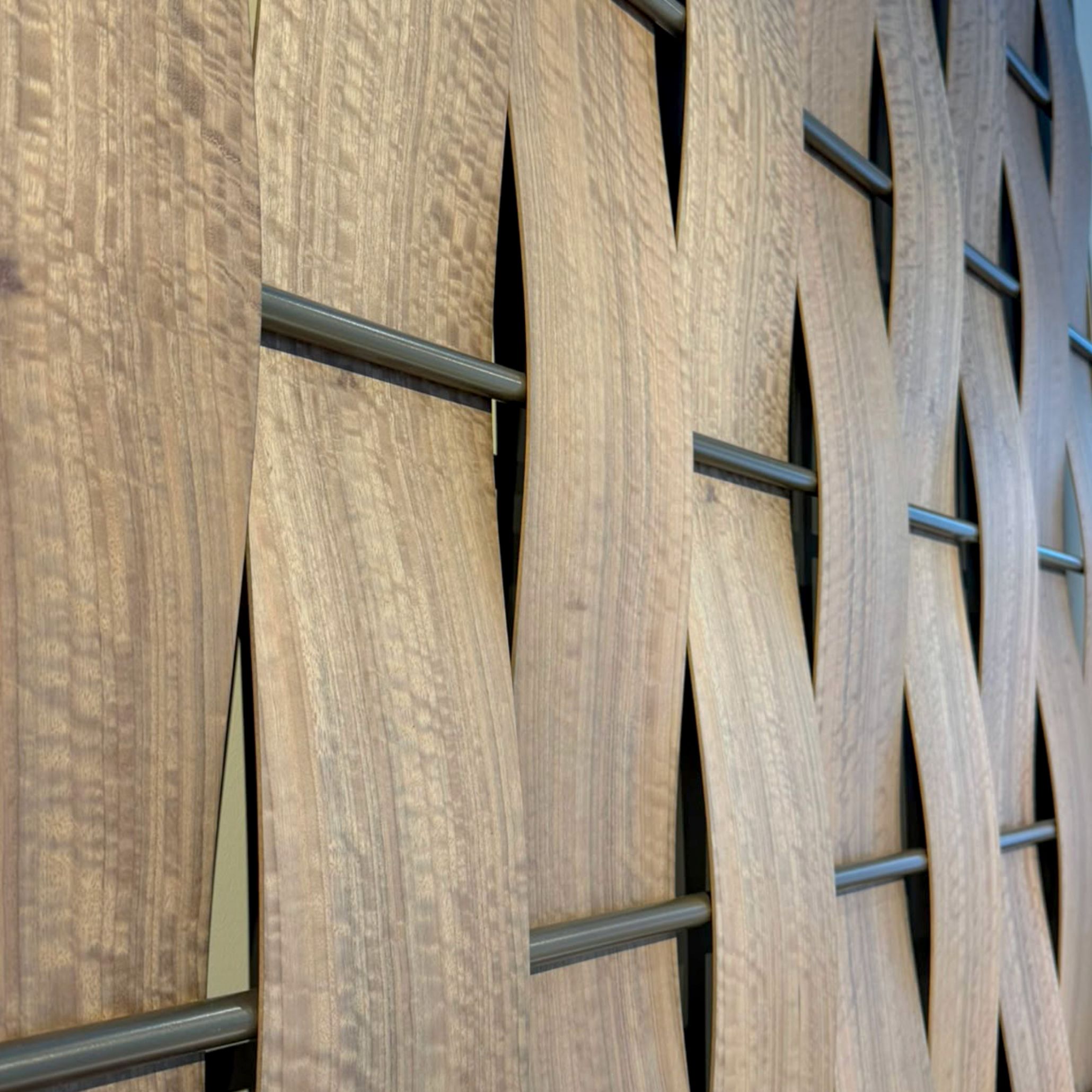A close-up view of an intricate woven wall panel made from natural wood grain veneers woven over horizontal metallic supports. Part of Stylish Club’s Rare Matter concept at Decorex 2026, this piece highlights finest wood finishes, rich wood texture, and exceptional design details rooted in sustainable artisan craftsmanship.