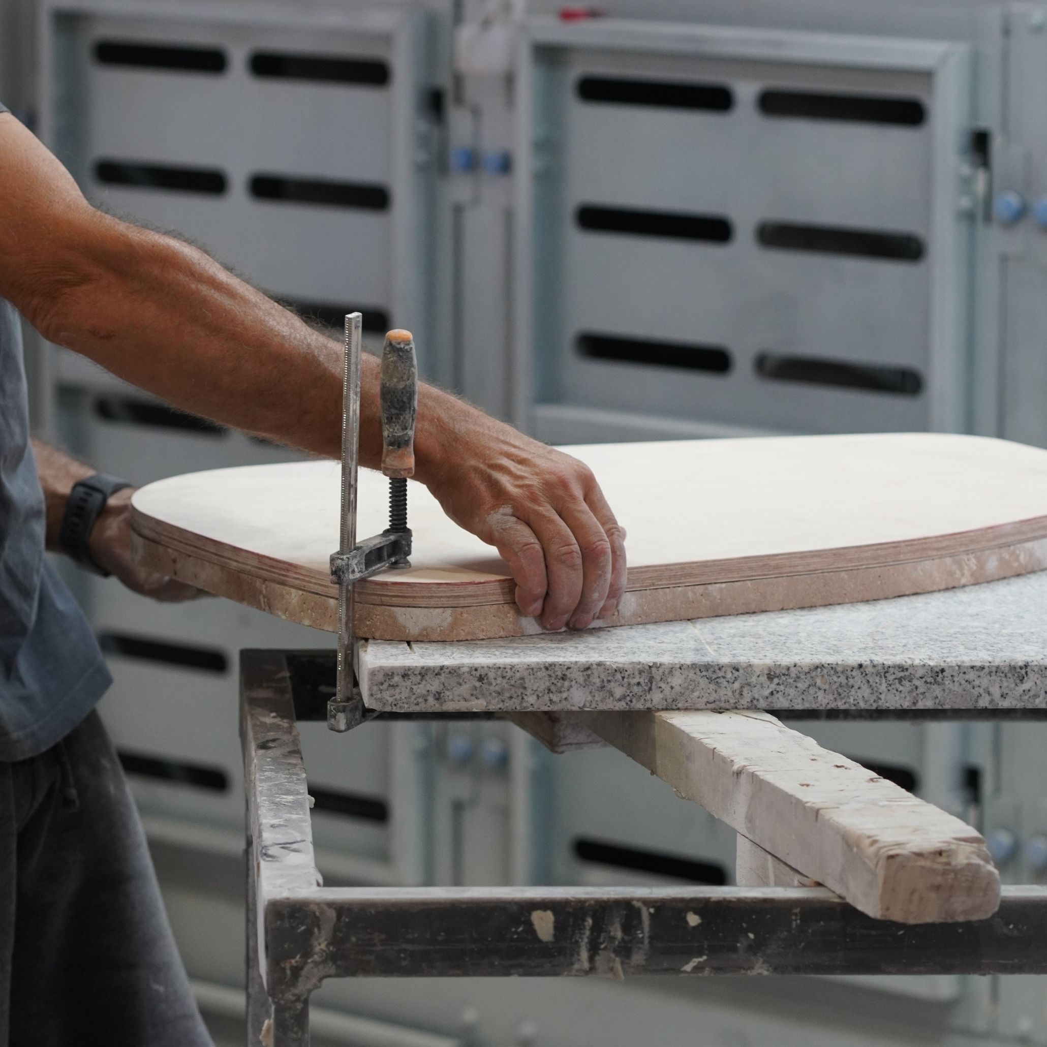 A close-up shot of an artisan using precision tools to shape a wooden panel in a workshop. This image demonstrates the best handmade techniques behind custom furniture and luxury handmade furniture, reflecting Stylish Club's focus on sustainable luxury and conscious creation.